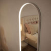 Sophia Full Length Arch Mirror with LED lighting and white frame, reflecting a cozy bedroom with a luxurious bed and soft decor.