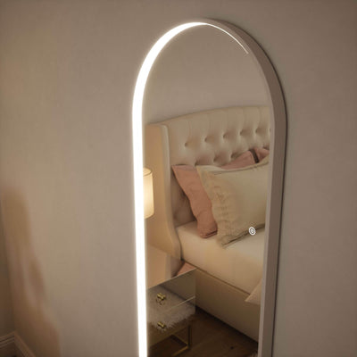 Sophia Full Length Arch Mirror with LED lighting and white frame, reflecting a cozy bedroom with a luxurious bed and soft decor.