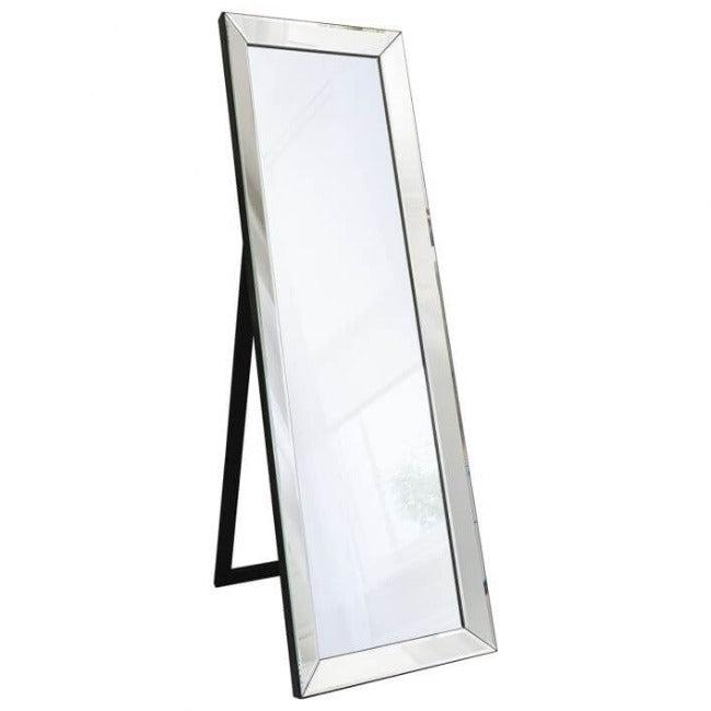 Angled Luna silver cheval mirror with elegant kick stand in a stylish room setting, featuring a decorative side table with a plant and vases.