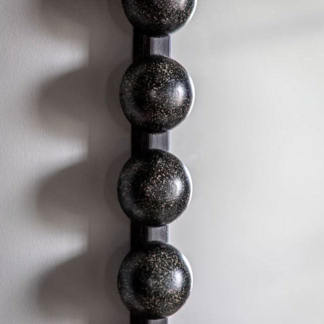 Close-up of Black Pill Mirror with oversized beading and bold black finish, modern and stylish decor.