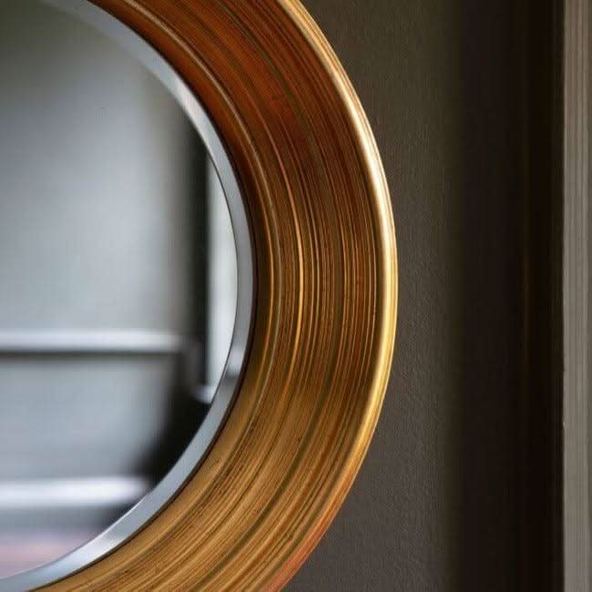 Close-up of gold leaf Chaplin Round Mirror, ideal for bold wall statement in bedroom or living area. 650mm width and height.