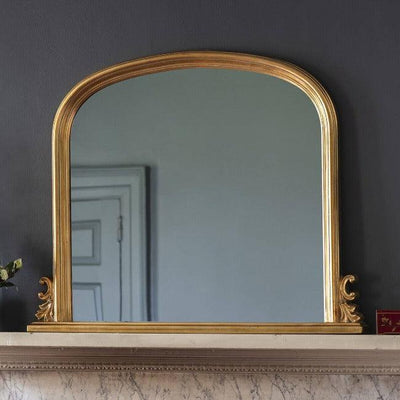 ornate gold over the mantle mirror with a round dome top