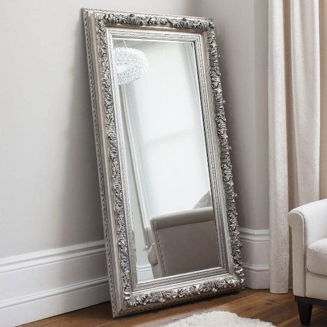 Silver ornate leaner full-length mirror in a bedroom setting with detailed frame, 173cm x 87cm, suitable for portrait or landscape orientation.